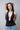 Structured Style Black Open-Back Plunging Peplum Blouse